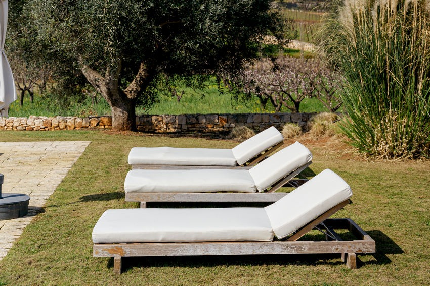 Trullo Petrarolo poolside with lounge area and nature