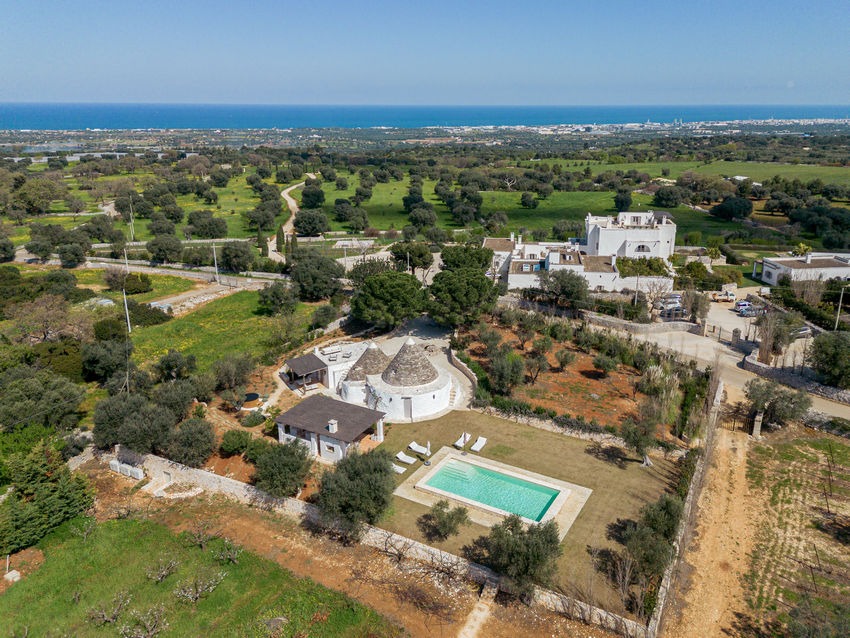 Trullo Petrarolo stay with traditional stone architecture in Italy. Top view