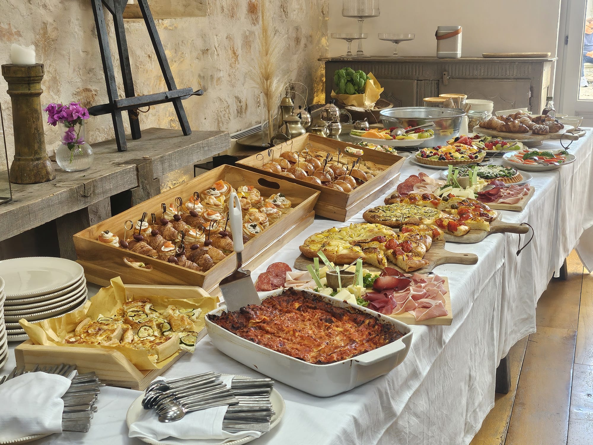Breakfast laid out with focaccia, pastries, fruit, cheeses and cured meats