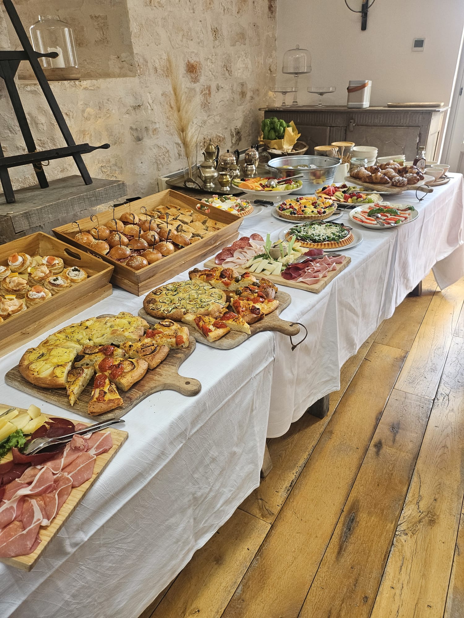A generous breakfast spread arranged on a linen-covered table