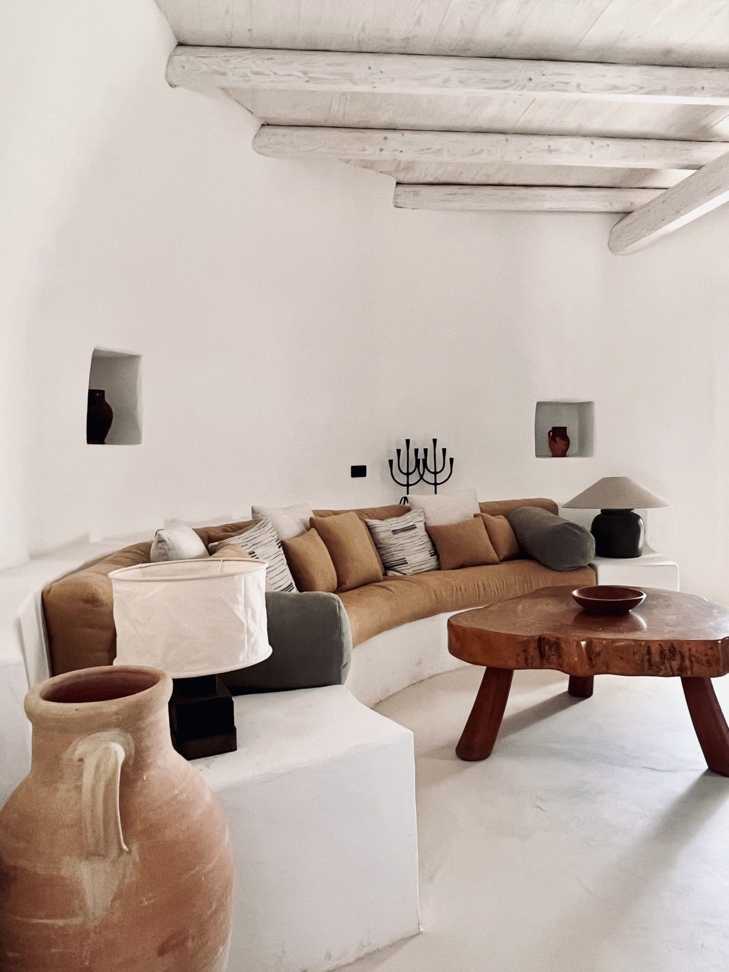 The curved sofa and stone walls in the Trullo living room